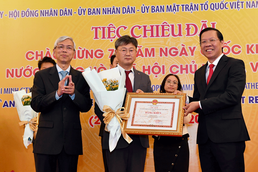 Chủ tịch UBND TPHCM Phan Văn Mãi tặng bằng khen cho các doanh nghiệp có nhiều đóng góp trong phòng chống dịch Covid-19. Ảnh: VIỆT DŨNG