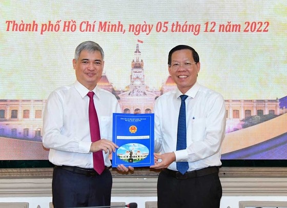 Chủ tịch UBND TPHCM Phan Văn Mãi trao quyết định bổ nhiệm cho ông Lê Duy Minh. Ảnh: VIỆT DŨNG